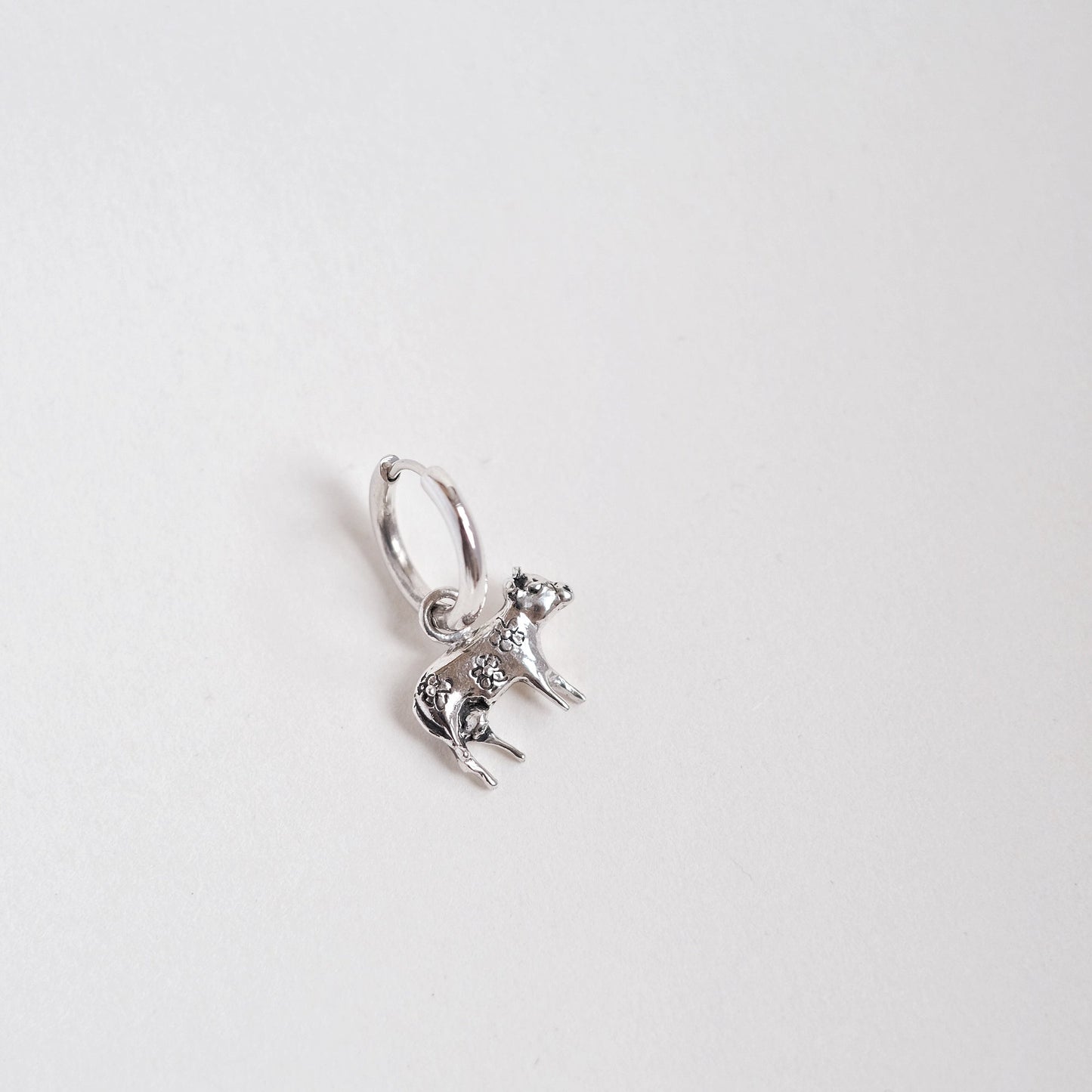 Moo-Moo cow earring worn on ear
